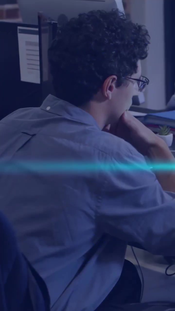 Vertical video: Male developer typing at desk, causing code glitch overlays while debugging app