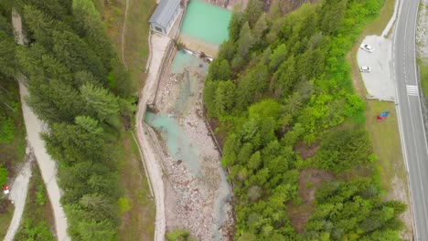 A-green-lake-behind-a-dam-in-the-Italian-Alps