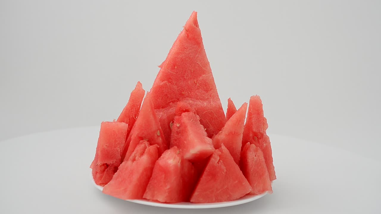 Shooting of a watermelon on a white background. Shooting in the movement