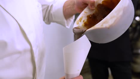 Pastry-Chef-Pouring-A-Delicious-Caramel-In-A-Cake-Piping-Bag