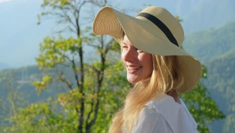 woman in straw hat at scenic mountain view