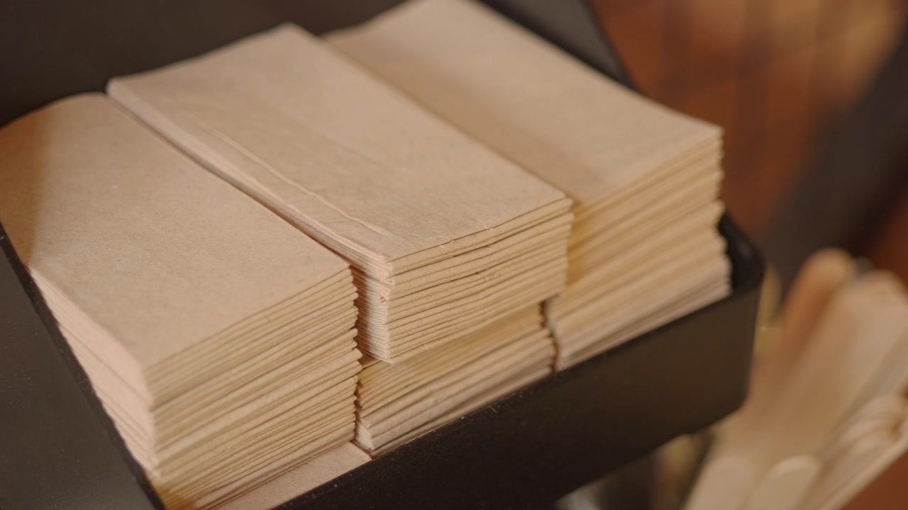 Stacks of Brown Paper Napkins in a Dispenser