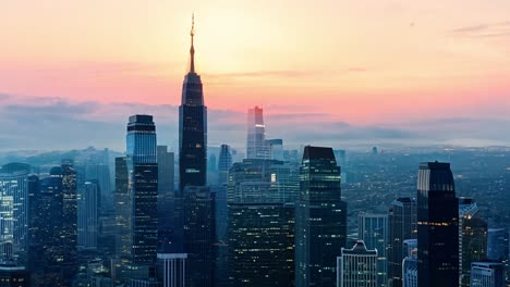 sunrise illuminating the empire state building and the manhattan skyline creates a stunning urban landscape