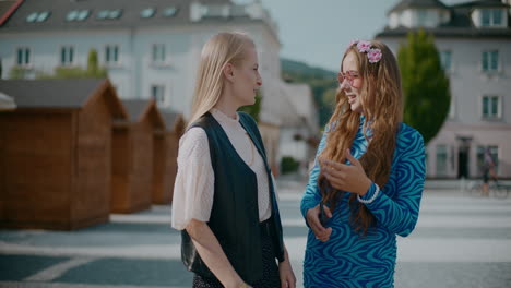 two young women talking on the street