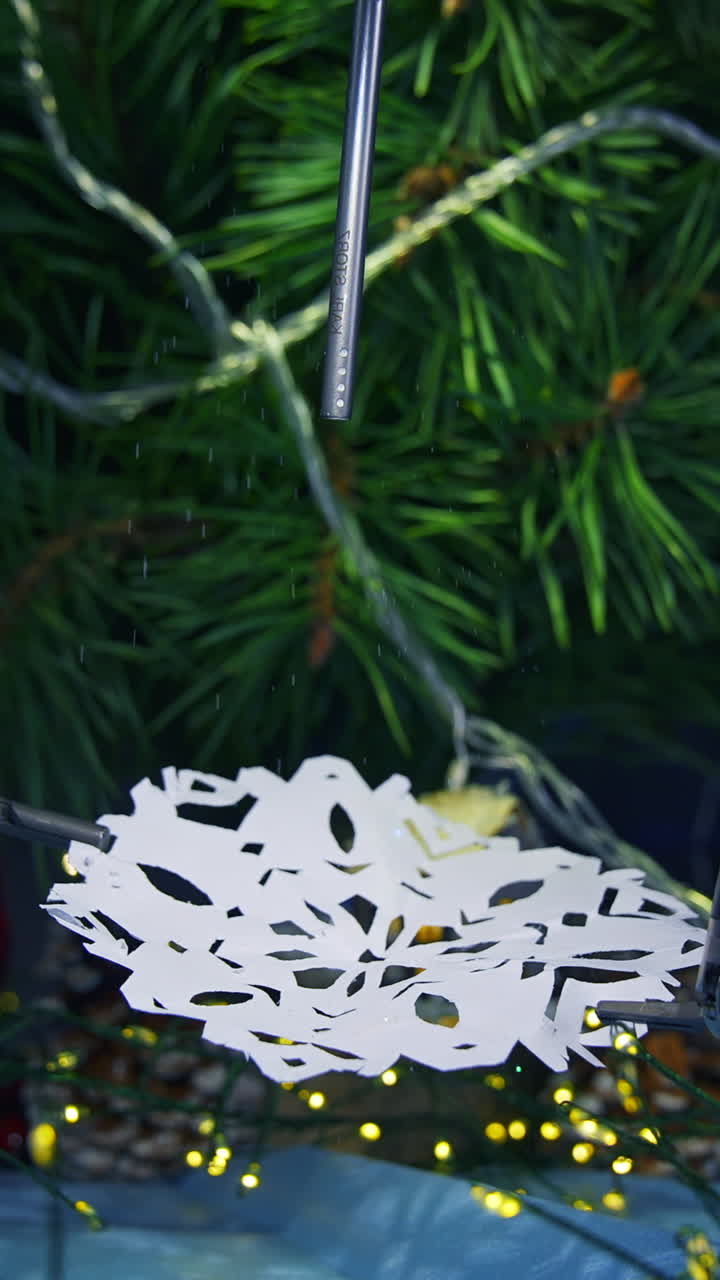 Smart intelligence preparing snowflake from paper while preparing to the Christmas. Cropped view. Future technologies concept. Vertical video