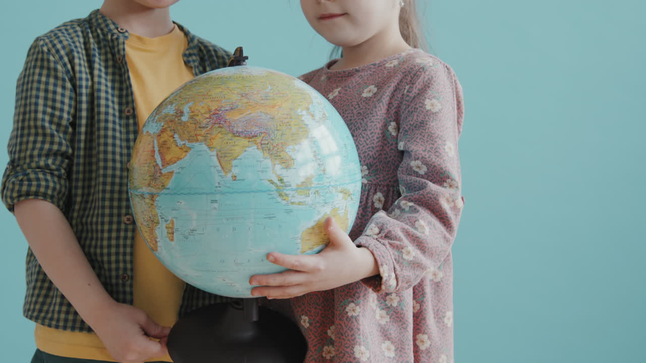 Cute Schoolchildren Posing with World Globe