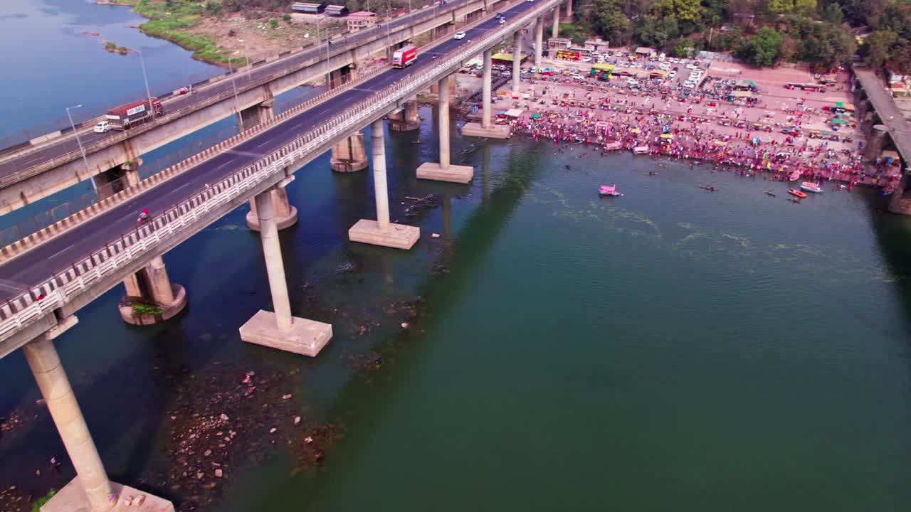 Narmada River Bridge with Narmada Ghat and agricultural land at Tilwara Bridge, Jotpur, Jabalpur, Madhya Pradesh, india. day time, pan shot, tilt up, drone shot, 4k.