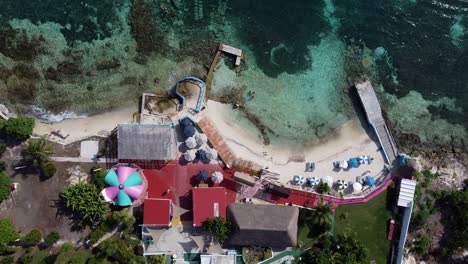 aerial drone bird's eye view over beautiful beach club at isla mujeres island in quintana roo, mexico at daytime