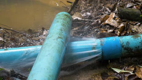 old blue pvc pipes leaking water