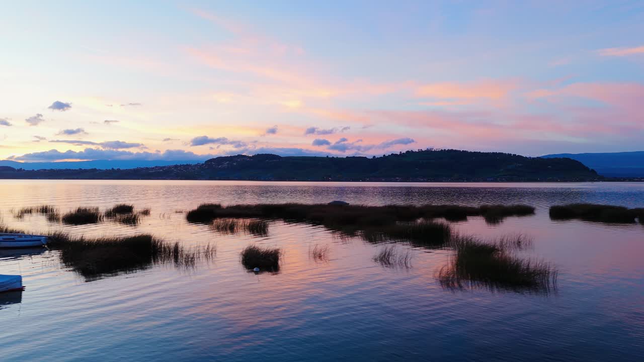 Landscape of the lake Murten in Switzerland with boats resting in the lake.
