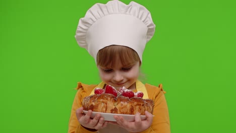 Child-girl-kid-dressed-as-cook-chef-sprinkle-strawberry-cake-with-icing-sugar,-chroma-key-background