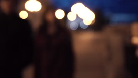 blurred people walking at night