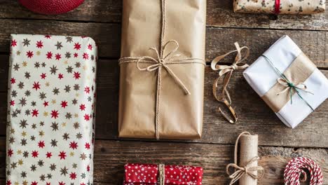 closeup of christmas presents wrapped in various papers with ribbons and bows