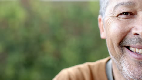 enjoying nature and fresh air, smiling senior man outdoors, copy space
