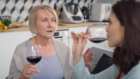 video of two generation women drinking wine at home