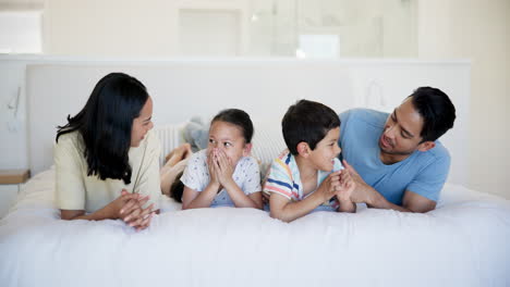 happy family playing on bed