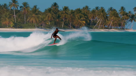 woman surfing on a tropical beach wave