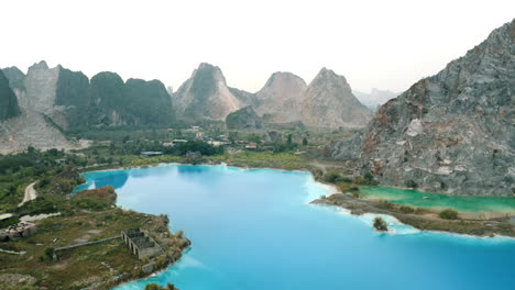stunning aerial view of a turquoise lake surrounded by mountains in china