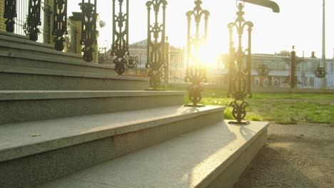 woman walking up stairs in a park at sunset