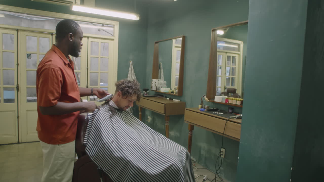 Barber Shaving Neck Hair of Client with Clippers in Old Fashioned Salon