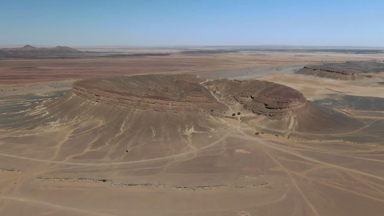 Horseshoe rock formation also called spectre crater of remote travel destination Gara Medouar in Morocco, aerial drone circling view
