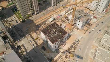 Aerial-establish-construction-site-with-cranes-in-residential-district