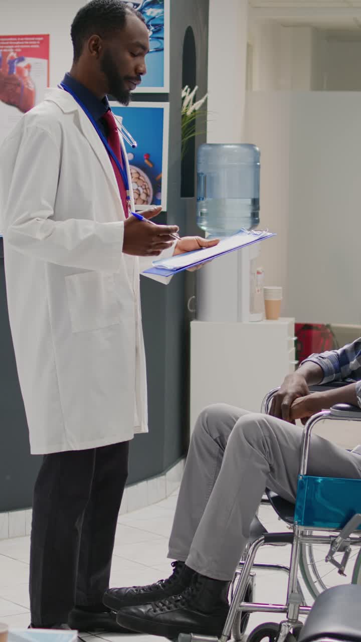 Vertical video: Nurse helping african american patient with disability