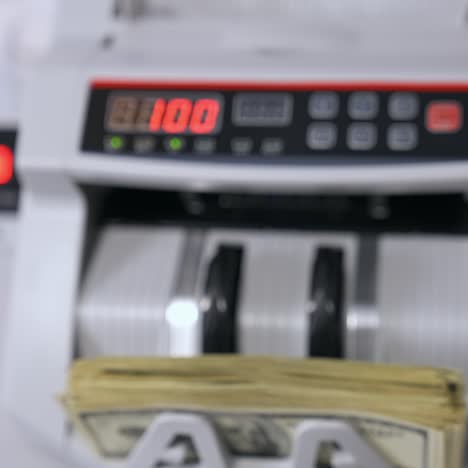 money counting equipment for paper money calculation. automatic mechanism for bank financial operations. currency exchange of one hundred usd