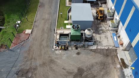 close-up of factory machinery: drone footage approaches the warehouse, showcasing the machines in motion