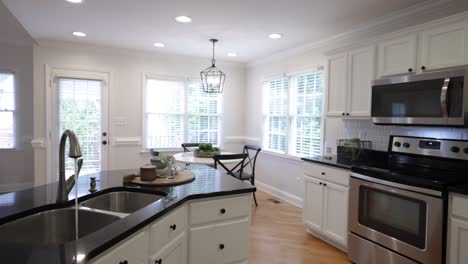 bright, white kitchen, fully equipped during day time.