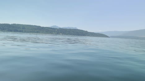 boating in the middle of the shuswap lake near salmon arm, british columbia, canada