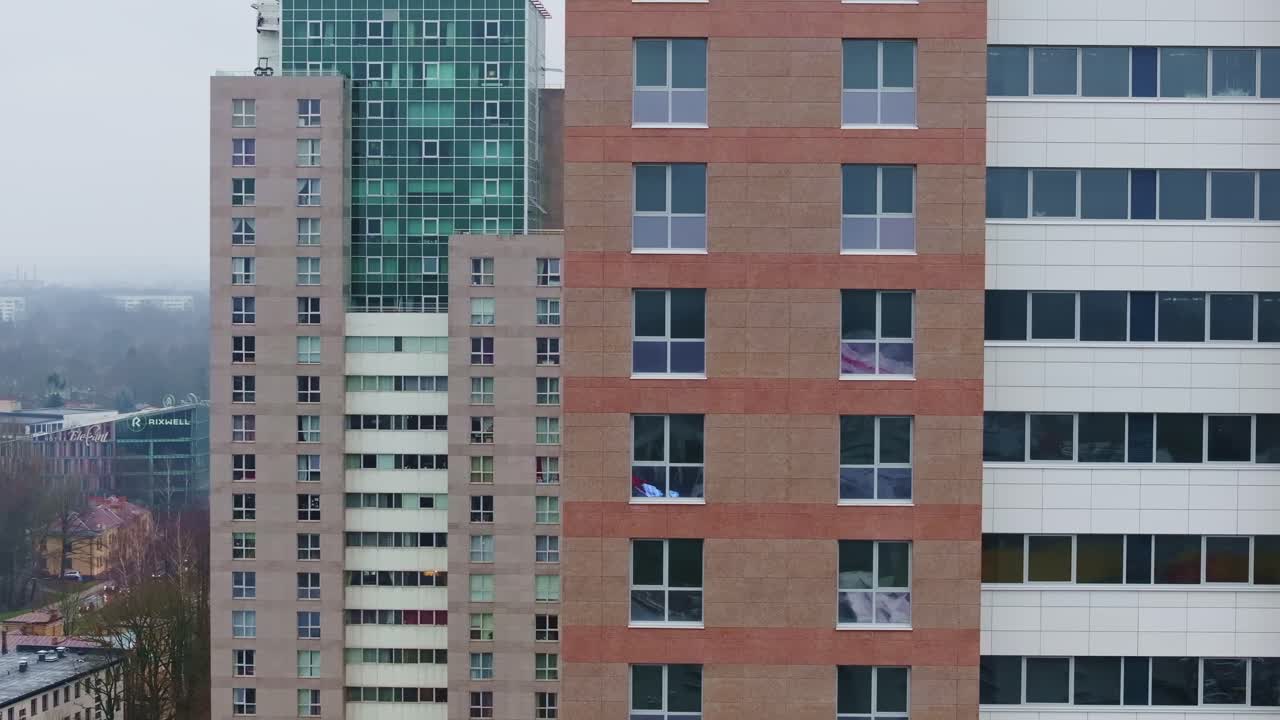Tight drone telephoto framing highlights modern tower symmetry in Pleskodāle