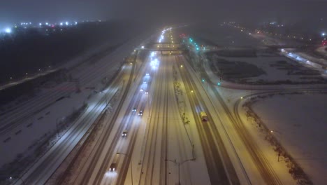 traffic slowing on snow-packed icy roads on a busy section of highway during the winter