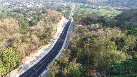 Aerial view, the new road that cuts through the hills from the city of Jogja to Gunungkidul passing the Banyunibo cliff climb