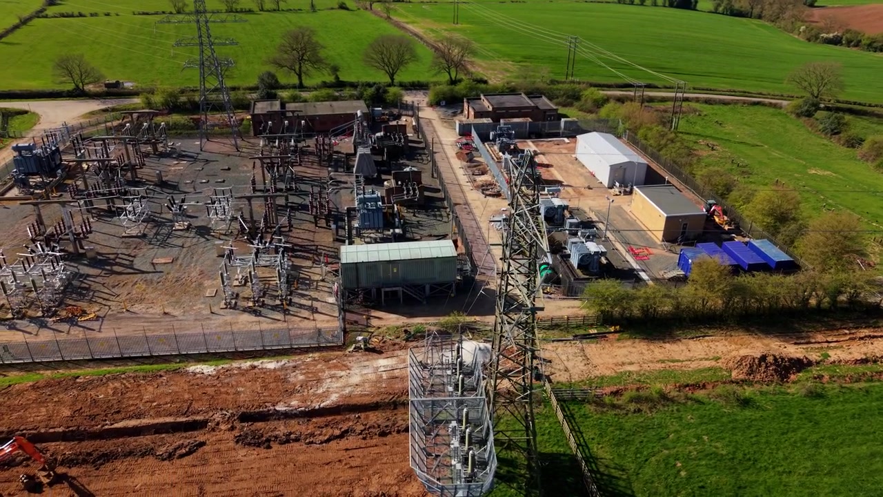 High-Angle Drone View of Grid Distribution Transformer and Switchgear Enclosure