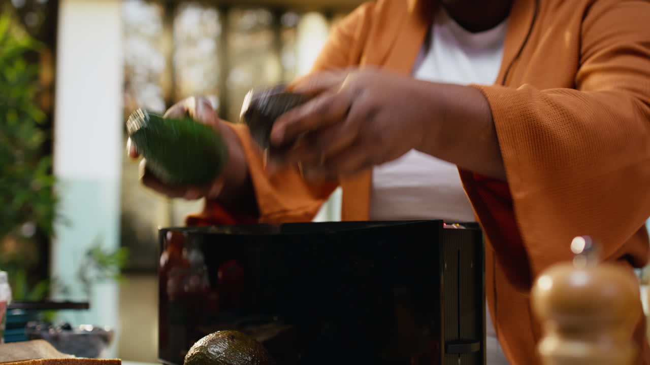 Close up African american chef filming preparation for healthy meal tutorial
