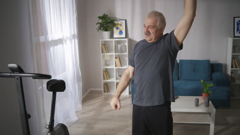 elderly man is doing physical exercises for vertebral home fitness and rehabilitation after injury healthy lifestyle