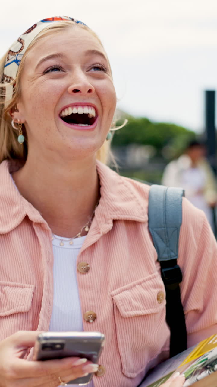 Smiling blonde woman with headband using smartphone outdoors