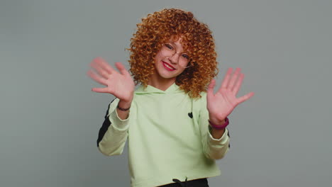 young teen school girl kid smiling friendly gesturing hello or goodbye welcoming waving hands