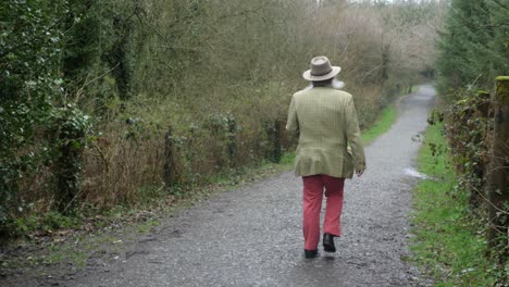 elderly man with beard walking down stone path