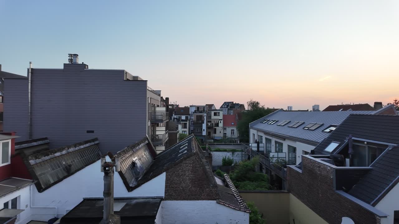Sunset light over rooftops and buildings in Belgian city