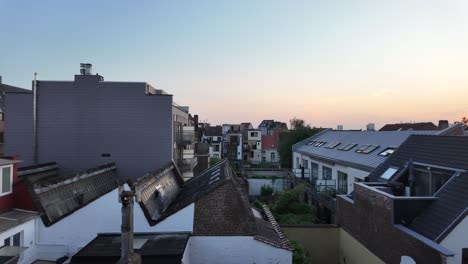 sunset light over rooftops and buildings in belgian city