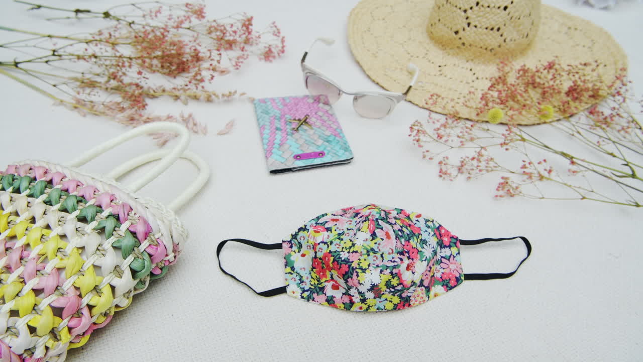 Post coronavirus travel flat lay new normal concept, mandatory face mask when going on a trip, colorful