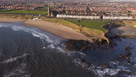 north side of tynemouth longsands beach and cullercoats with relaxing waves on spring morning
