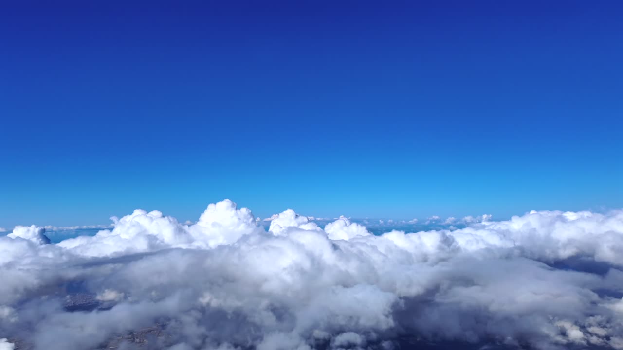 An immersive fighter jet pilot´s view while flying above some cottony clouds climbing in a adeep blue sky