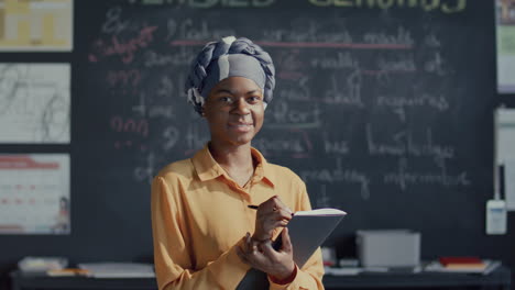 portrait of young black female student smiling happily in classroom