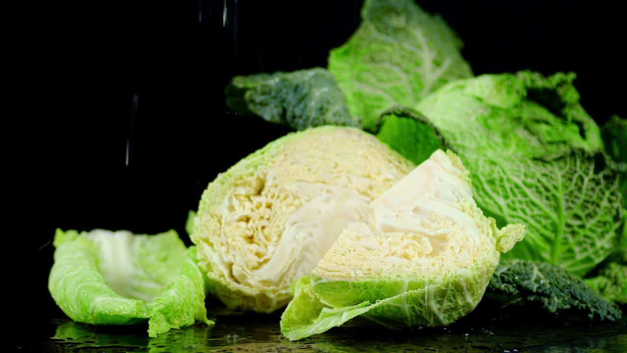 Fresh cabbage falling water drops.