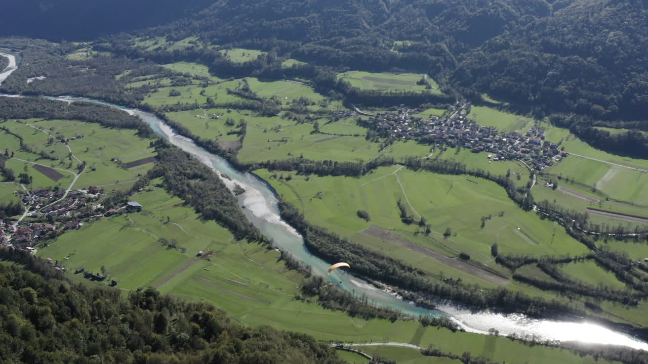 Aerial View of a Valley with Paraglider
