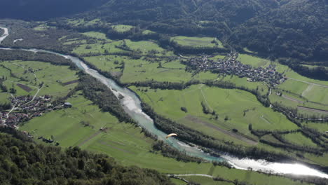 aerial view of a valley with paraglider