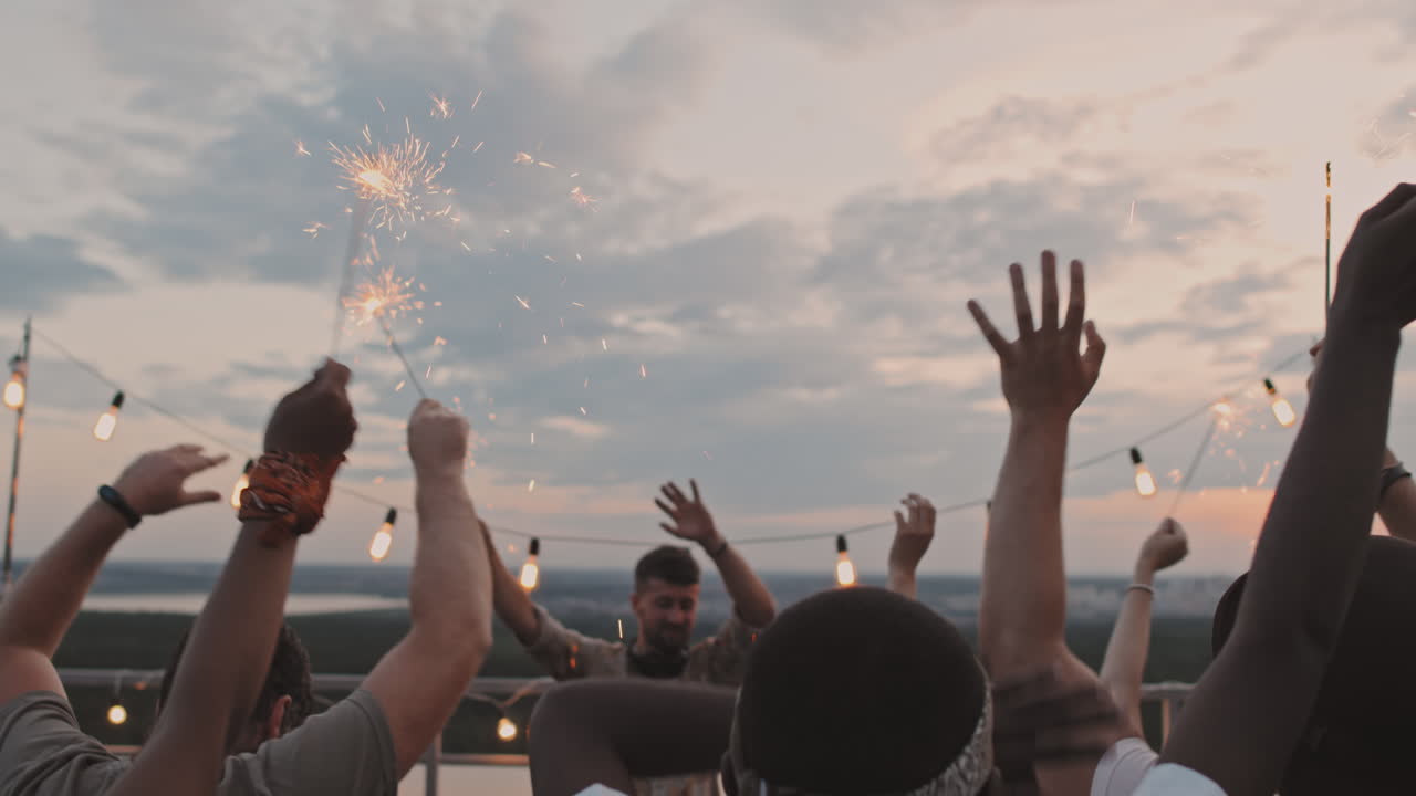 People with Sparklers Partying on Rooftop